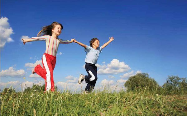 2 kids running in open field