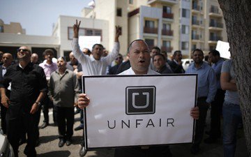 Uber drivers protest against working conditions outside the company's office in Santa Monica